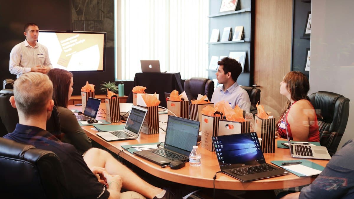 A trainer presenting to a team in a boardroom