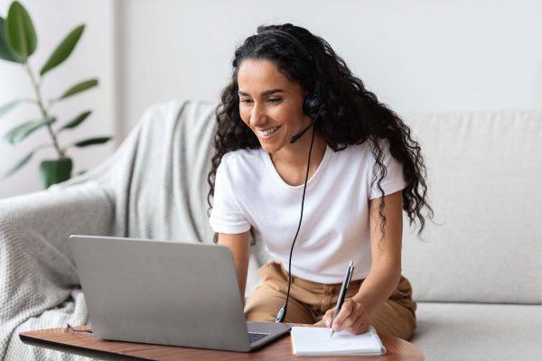 joyful young woman studying online using laptop a 4WUARFK
