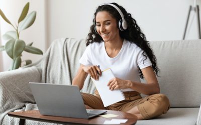 cheerful-lady-attending-online-course-using-laptop-and-wireless-headset.jpg